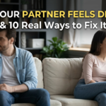 A couple sitting on opposite ends of a sofa looking away from each other, illustrating emotional distance in a relationship, with the blog title 'Why Your Partner Feels Distant & 10 Real Ways to Fix It' overlaid on top.